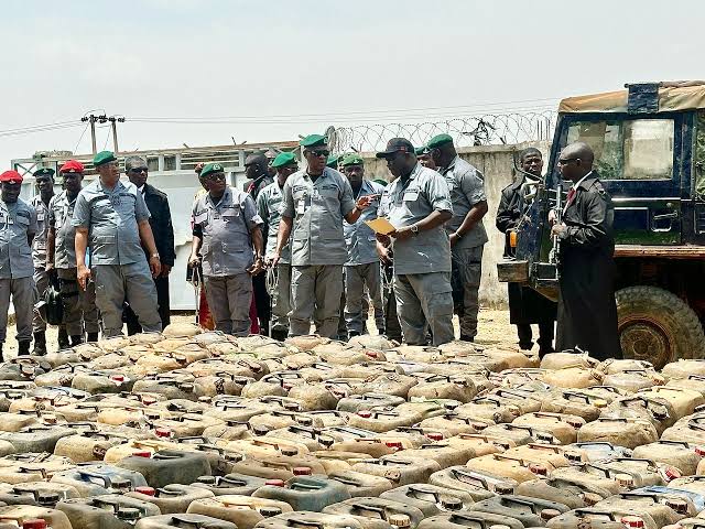 Nigeria Customs officers inspect over 1,100 jerrycans of smuggled fuel seized at the Taraba-Cameroon border during an anti-smuggling operation.